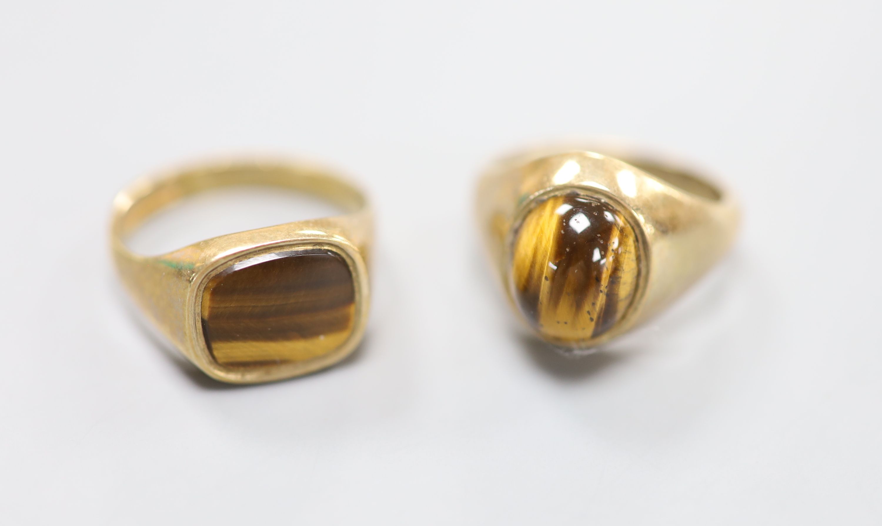 Two modern 9ct gold and tiger's eye quartz set signet rings, sizes S & U/V